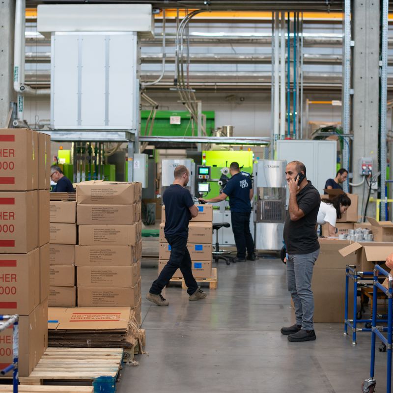 Workers packing goods on a production floor