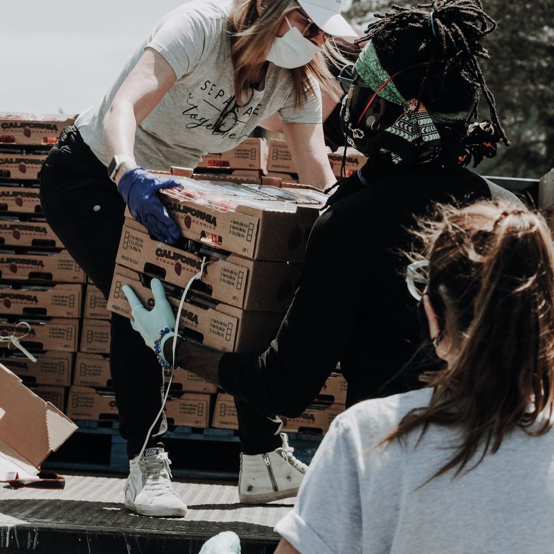 Crates of fresh produce being loaded onto a truck